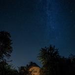 Milky Way over thatched house