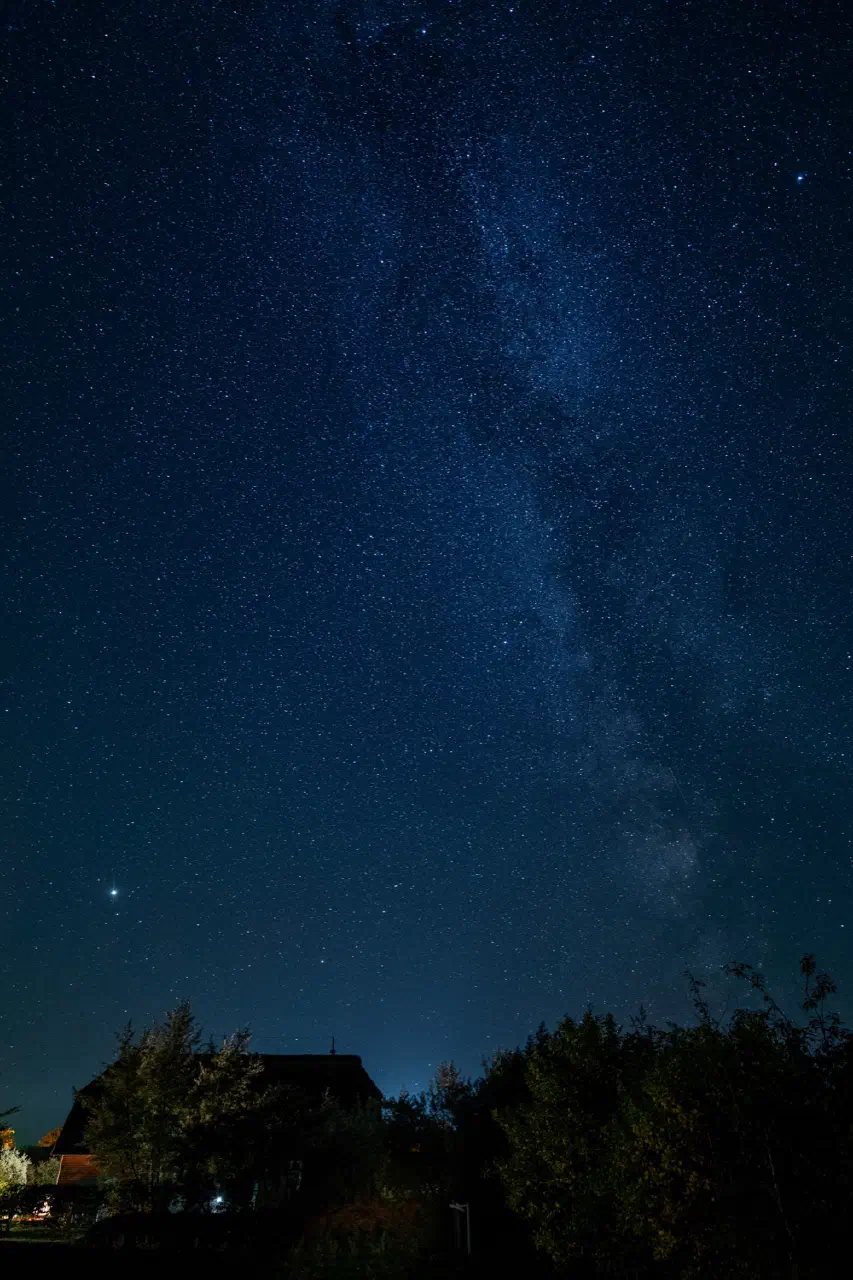 Milky Way over thatched house